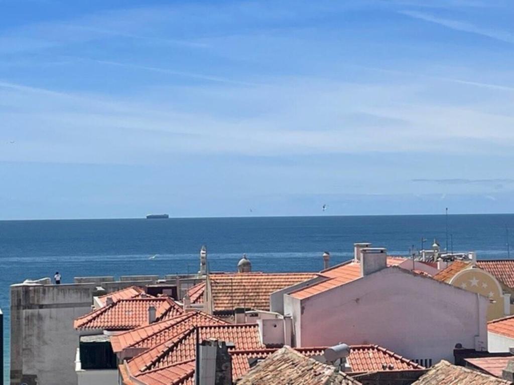a view of the ocean from the roofs of buildings at Sesimbra Universal in Sesimbra