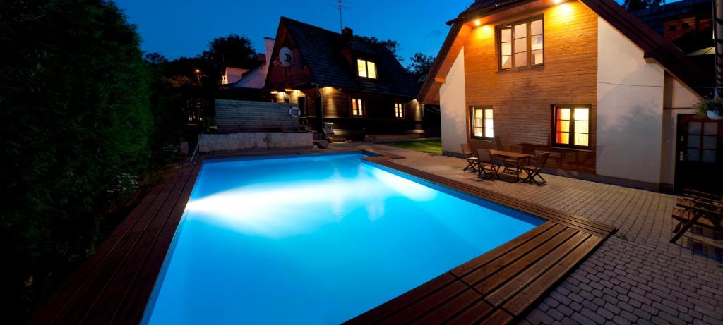 a swimming pool with blue lights in a yard at Cztery Pokoje in Kazimierz Dolny