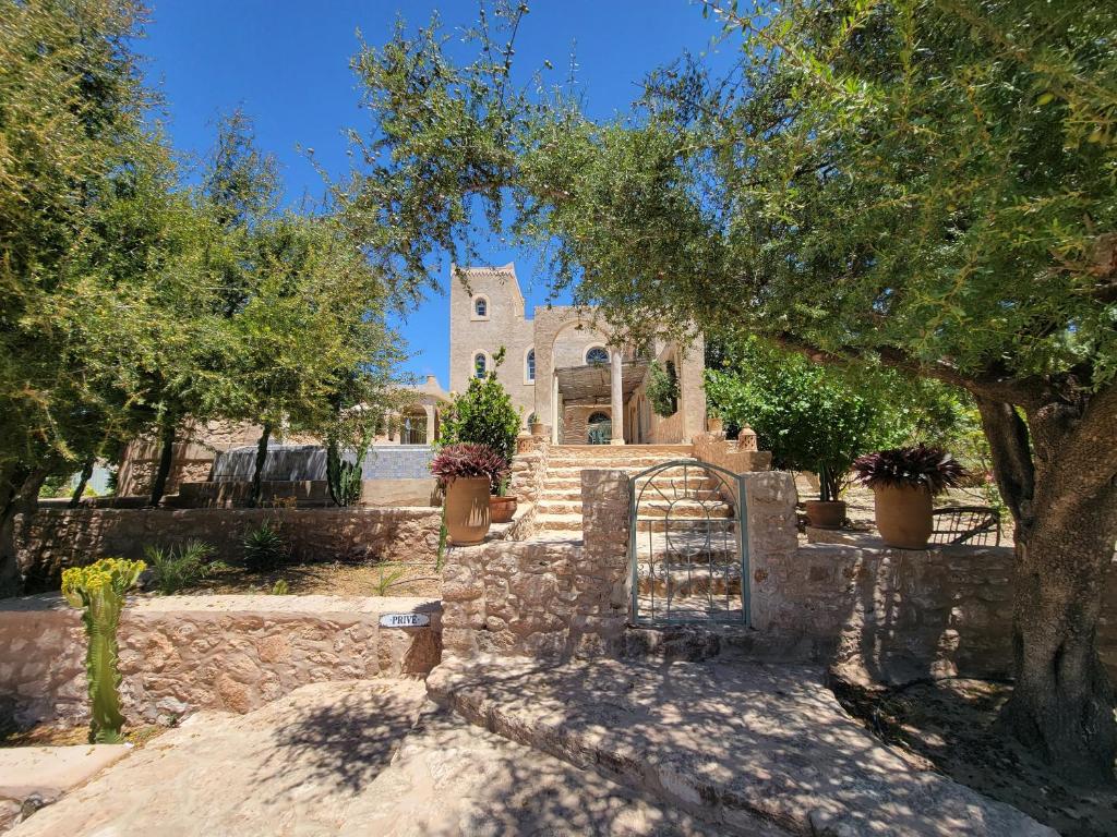 a gate in front of a stone building with a church at Dar Ez-zine in Ounara