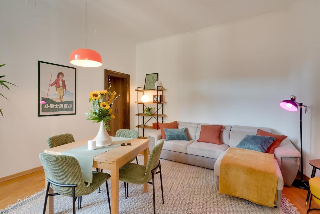 a living room with a couch and a table at Chromatica - di fronte a Galleria Bomb in Gorizia