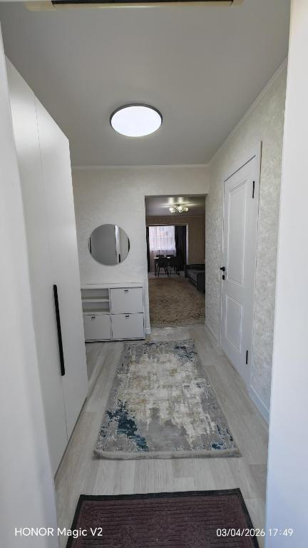 a room with a hallway with a door and a rug at Aktau 4-31 in Aktau