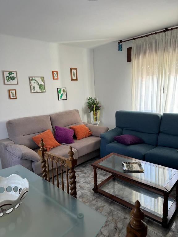 a living room with two couches and a coffee table at Casa de la bis in A Guarda