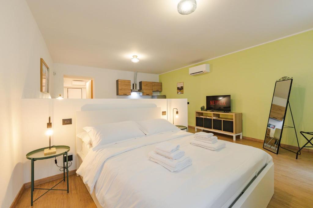 a bedroom with a white bed with towels on it at NEW Tocai – in via Rastello per 4 pp in Gorizia