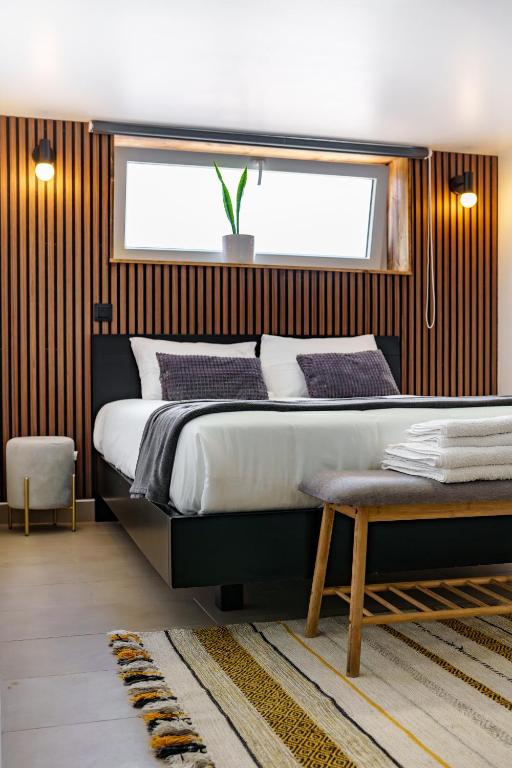 a bedroom with a large bed and a window at Cantinho da Susana in Coimbra