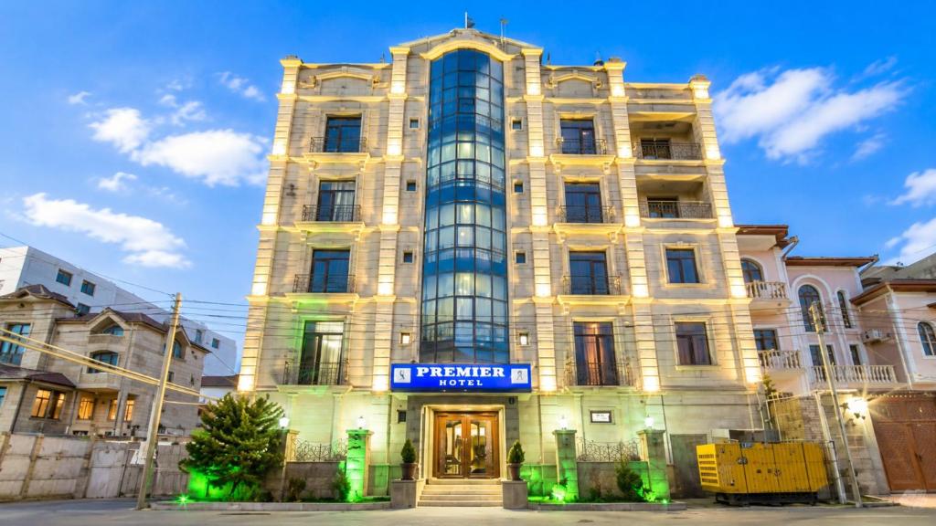 a tall building with a sign in front of it at Premier Hotel in Baku