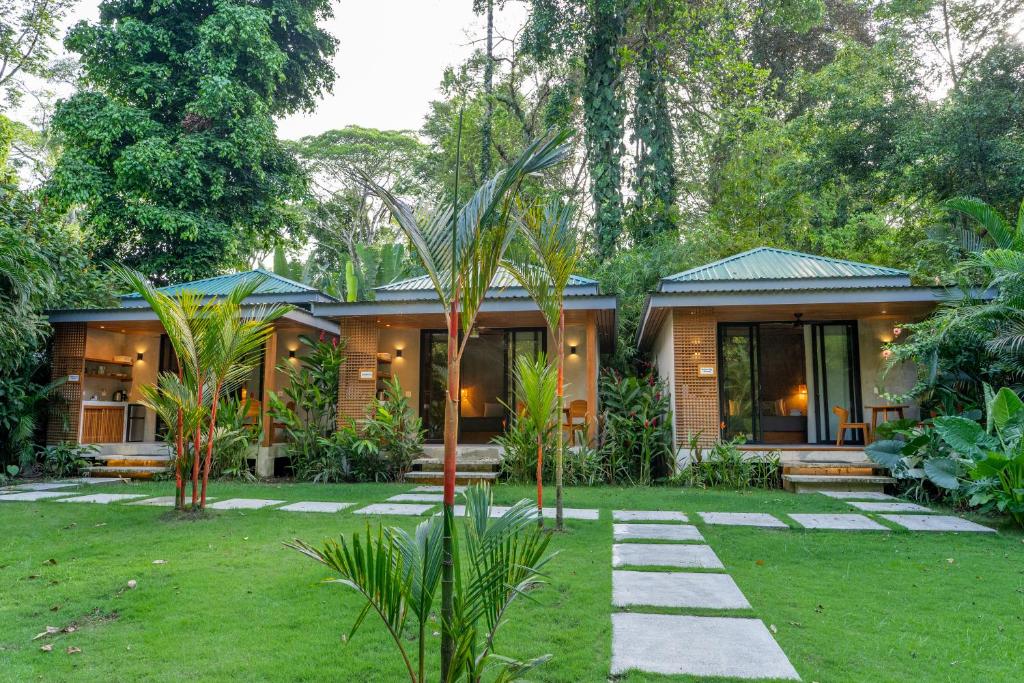 a house with a garden in front of it at Serenity Bungalow in Cocles