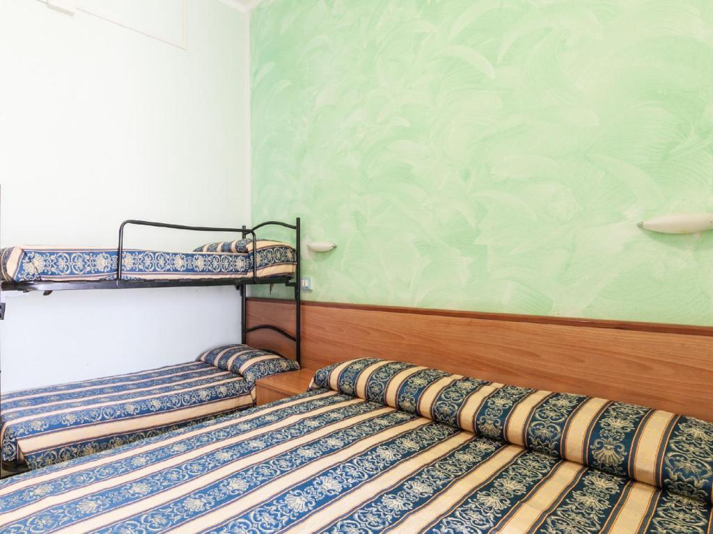 Postel nebo postele na pokoji v ubytování Hotel Promenade Universale