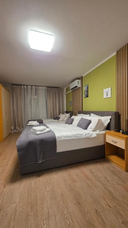 a large bedroom with a large bed and a desk at Vivo Bovec in Bovec