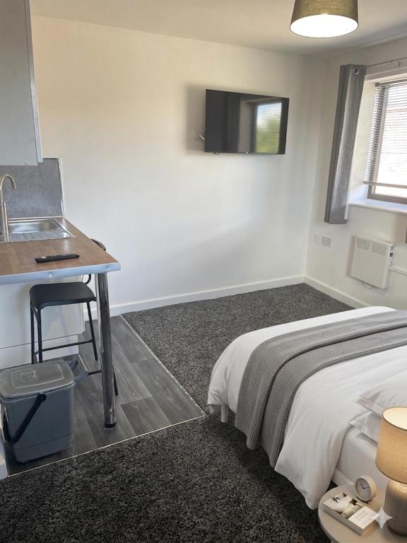 a bedroom with a bed and a desk and a sink at Jayden house in Middlesbrough