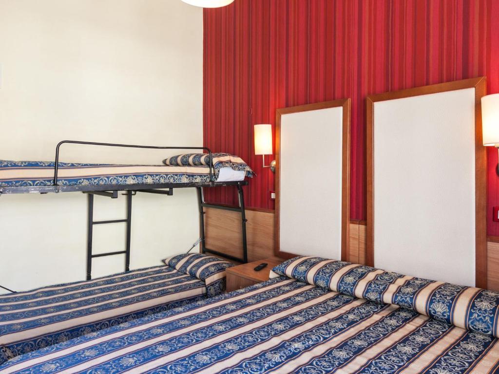 Postel nebo postele na pokoji v ubytování Hotel Promenade Universale