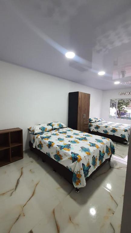 a bedroom with two beds in a room at Pachamama House in Bucaramanga