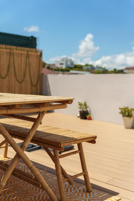 a wooden picnic table sitting on top of a patio at SuCaSa Full house with terrace 5 min from centre in Coimbra