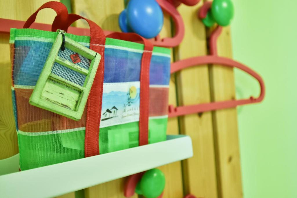 a bag hanging on a shelf next to a toy fence at Lane Homestay in Dayin