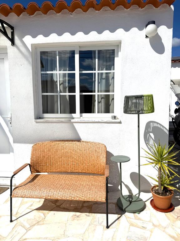a bench sitting on a patio next to a window at Casa da Calma - GUESTHOUSE in Alandroal