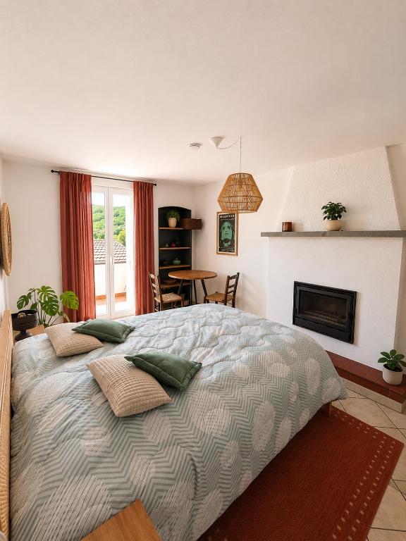 a bedroom with a large bed and a fireplace at Cà di Gabriel in Miglieglia