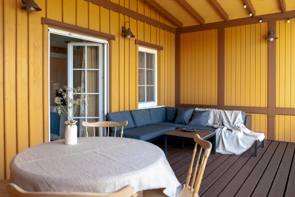 a living room with a blue couch and a table at Anties Namai in Juodkrantė