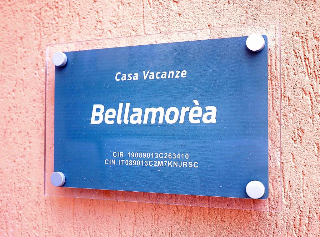 a blue sign on the side of a wall at Bellamorèa in Noto