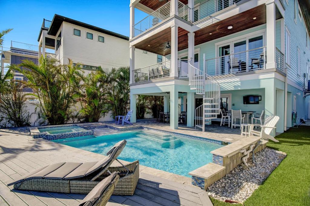 a home with a swimming pool and a house at Bayfront Retreat in Bradenton Beach