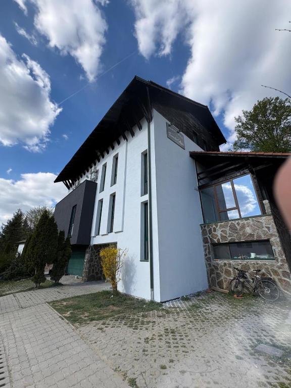a white building with a black roof at Franzdorf Alpin in Văliug