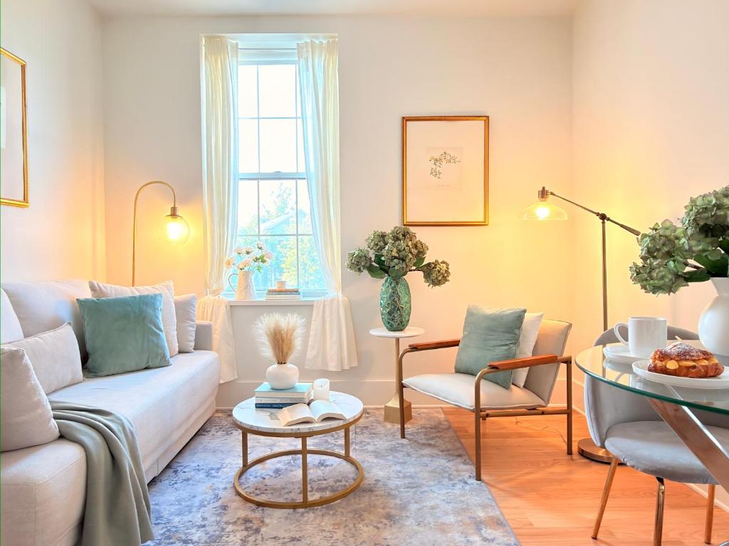 a living room with a couch and chairs and a table at Fox Point Landing Residences in Providence