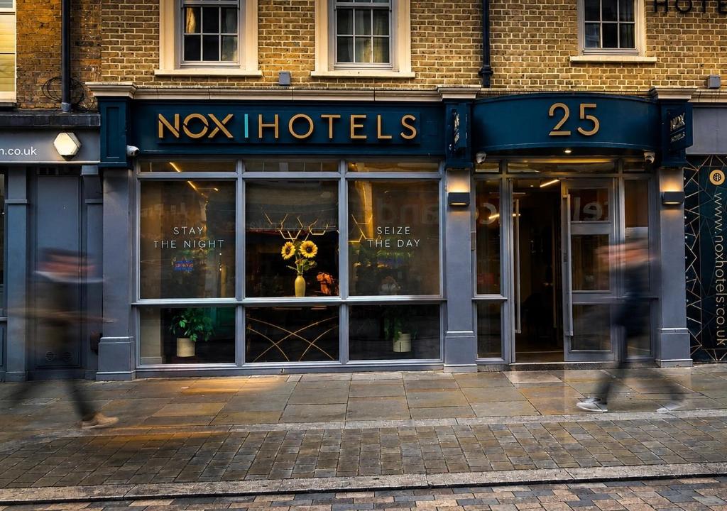 a store front with people walking in front of it at NOX Waterloo in London