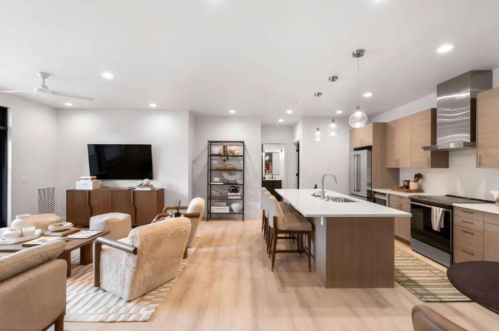 a kitchen and living room with a couch and a table at Refined Big Sky Luxury Condo in Big Sky