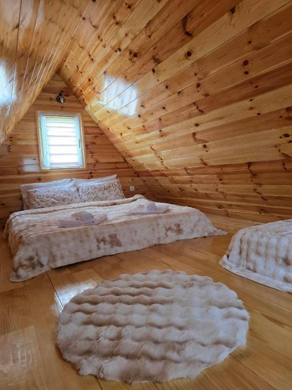 a room with two beds in a log cabin at Cottage Martina in Žabljak