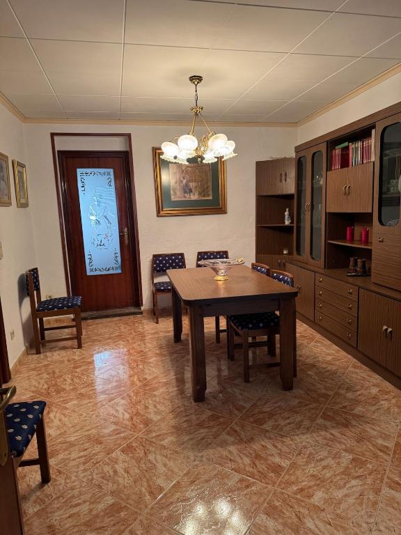 a dining room with a wooden table and chairs at Casa en Manuel in Manuel