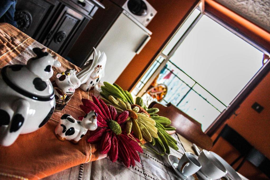a table with a vase of flowers on top of it at B&B Pian Savin in Giaveno