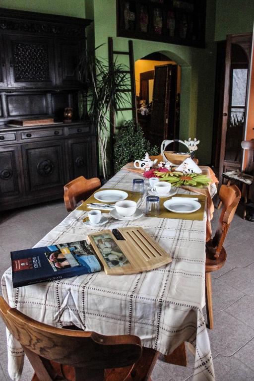 a dining room table with a book on top of it at B&B Pian Savin in Giaveno