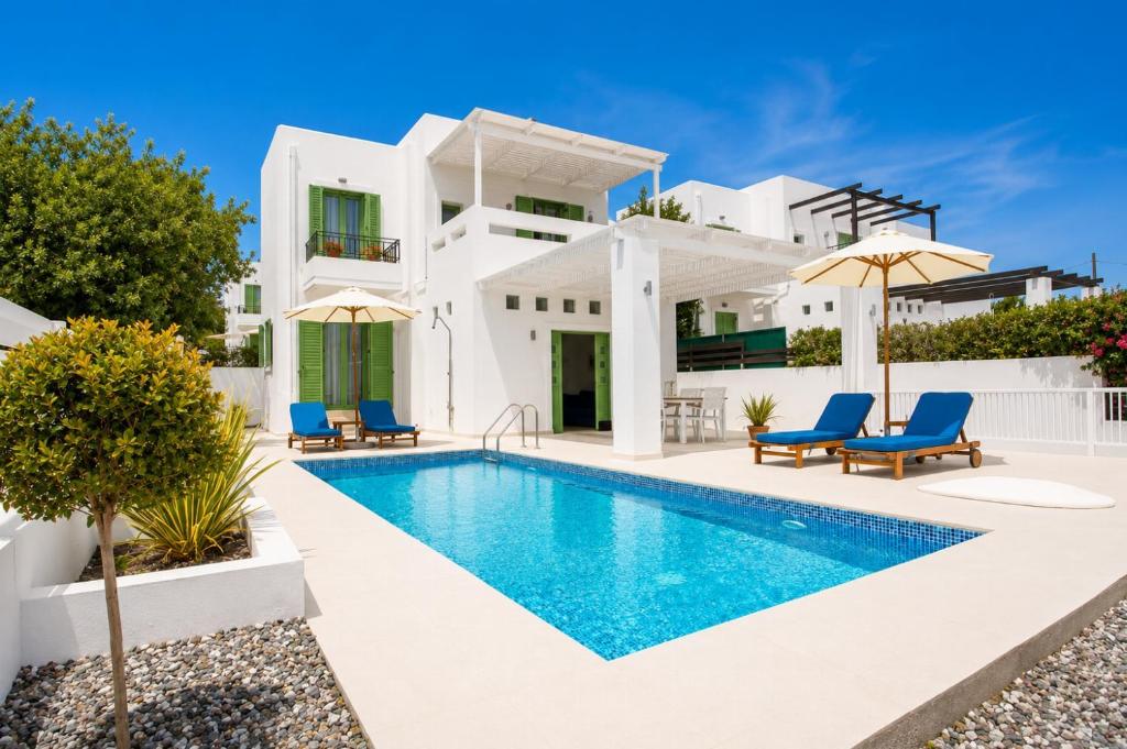 a villa with a swimming pool and a house at Villa Mytikas in Gennadi