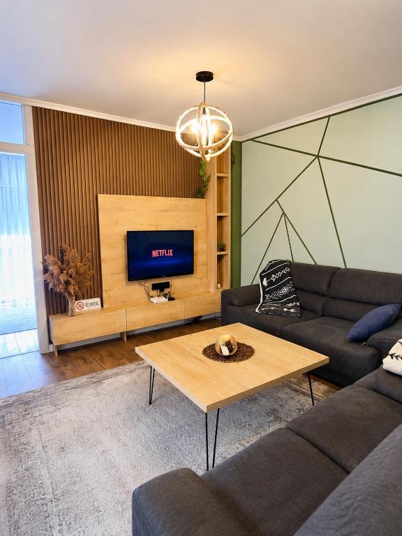 a living room with a couch and a coffee table at Nessii Apartment in Prishtinë