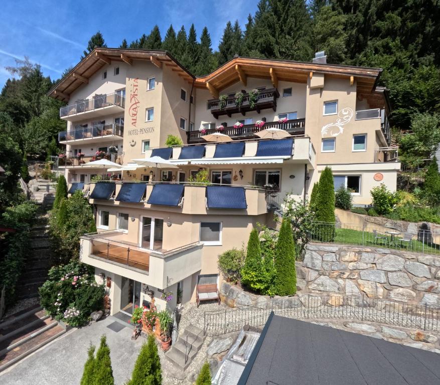 a building with solar panels on the side of it at Hotel Alta Vista in Neukirchen am Großvenediger