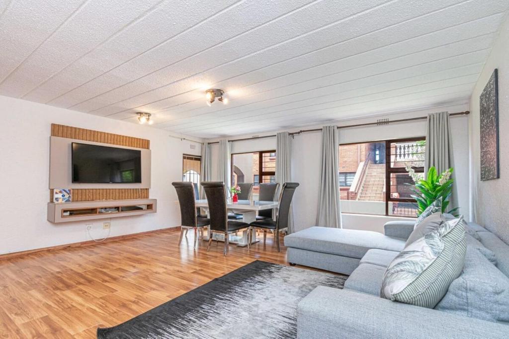 a living room with a couch and a table at 3 bed ground in sandton in Johannesburg