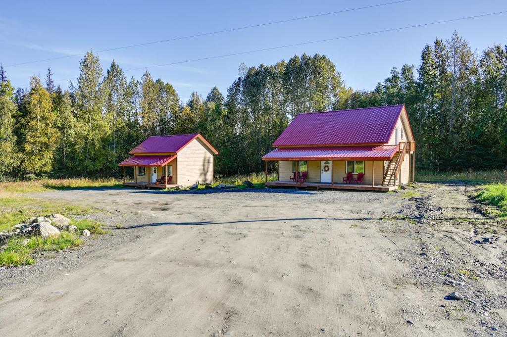 a house with a red roof next to a dirt road at Kenai River Base! Spacious 2-Unit Cabin Compound in Soldotna
