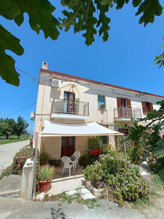 a building with a balcony and a table and chairs at B&B La Ciammaruca in Pollutri