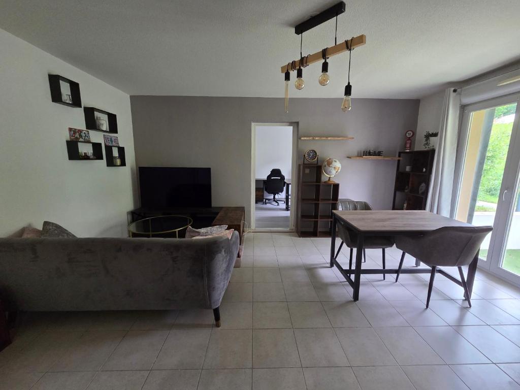 a living room with a couch and a table at Appartement à Nailloux in Nailloux