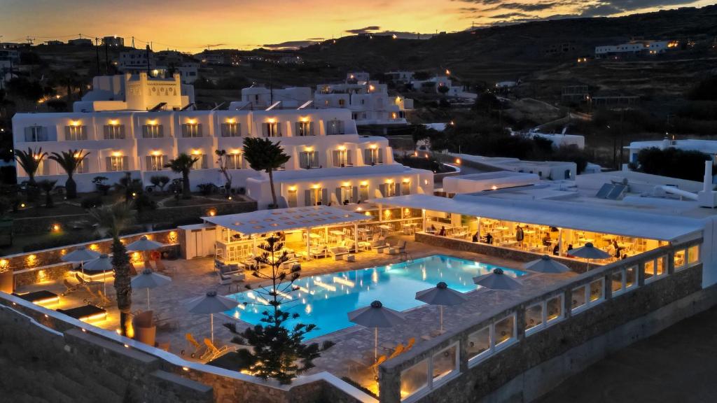 a view of a hotel with a pool at night at Yiannaki Hotel in Ornos