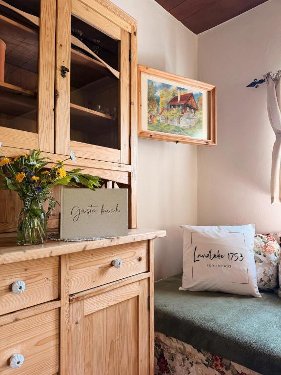 a bedroom with a wooden dresser and a cupboard at Ferienhaus Landliebe 1753 in Bad Gleichenberg
