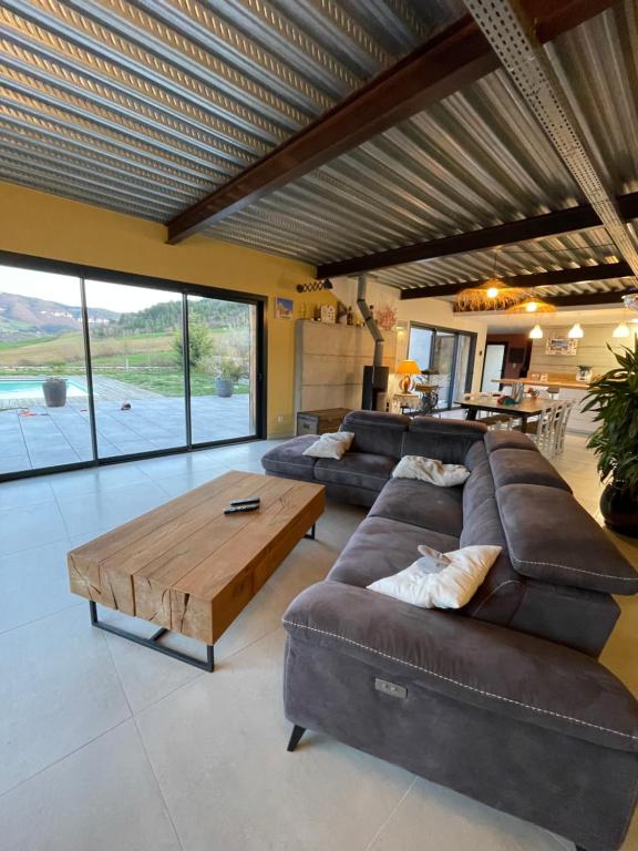 a living room with a couch and a coffee table at Villa Millau-gorges du Tarn in Aguessac