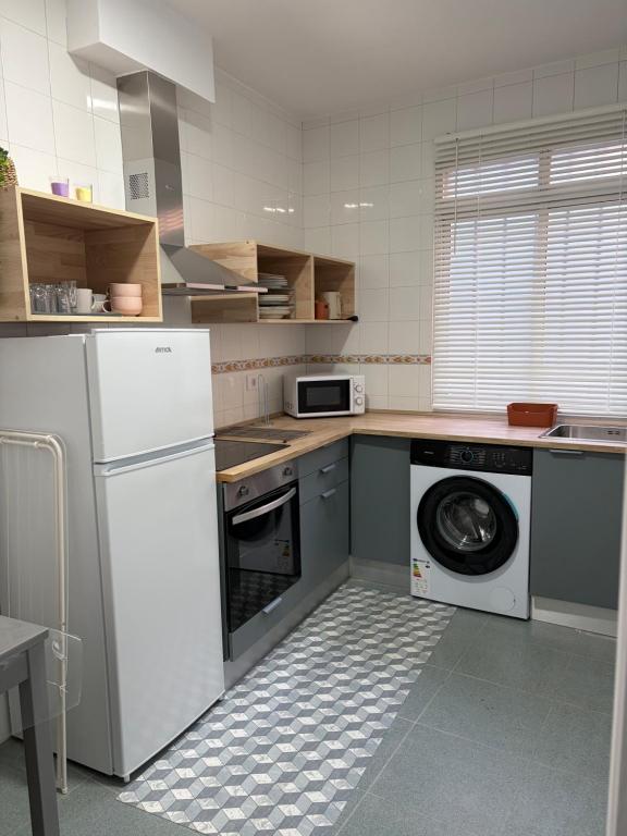 a kitchen with a washing machine and a dishwasher at Apartamento Nordés in A Guarda