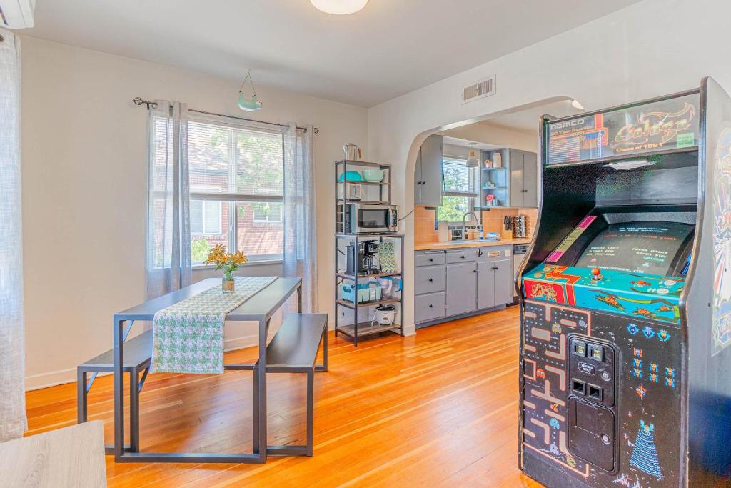 a dining room with a table and a video game at Midtown Sanctuary w Pac-Man in Reno