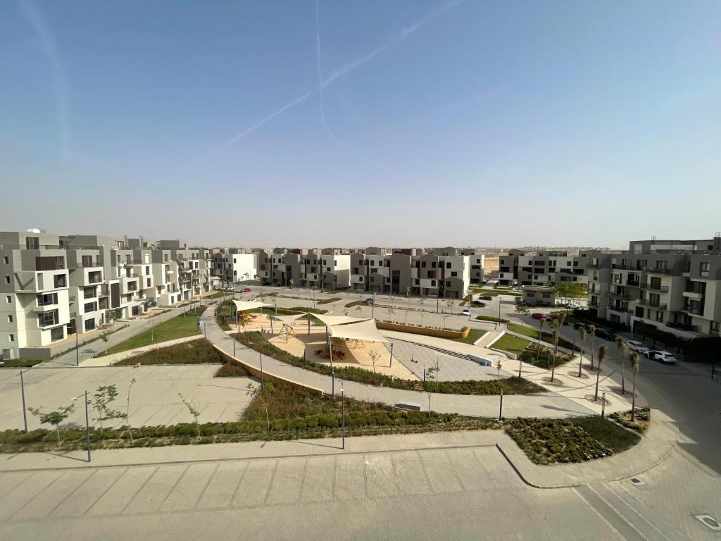 arial view of a city with buildings and a skate park at Modern Rooftop with Stunning View Iconic Tower in Madīnat aţ Ţalāʼi‘