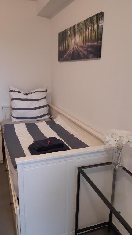 a small bed in a small room with at Zimmer auf Bauernhof in Kürten