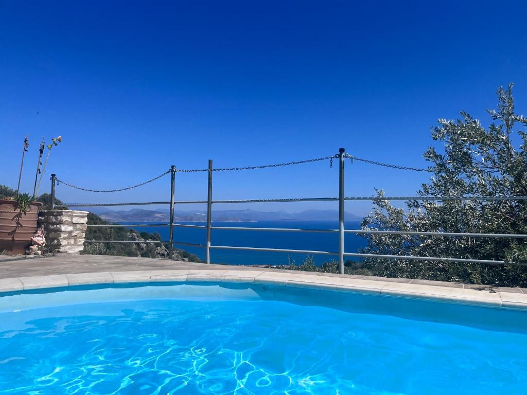 a swimming pool with a view of the water at The Grimme Residence in Xiropigado