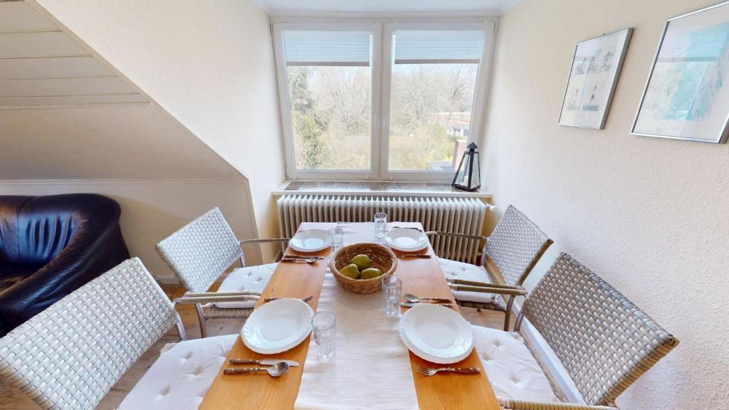 a dining room with a table and chairs and a window at Landhaus Gerdts - 4 in Cuxhaven