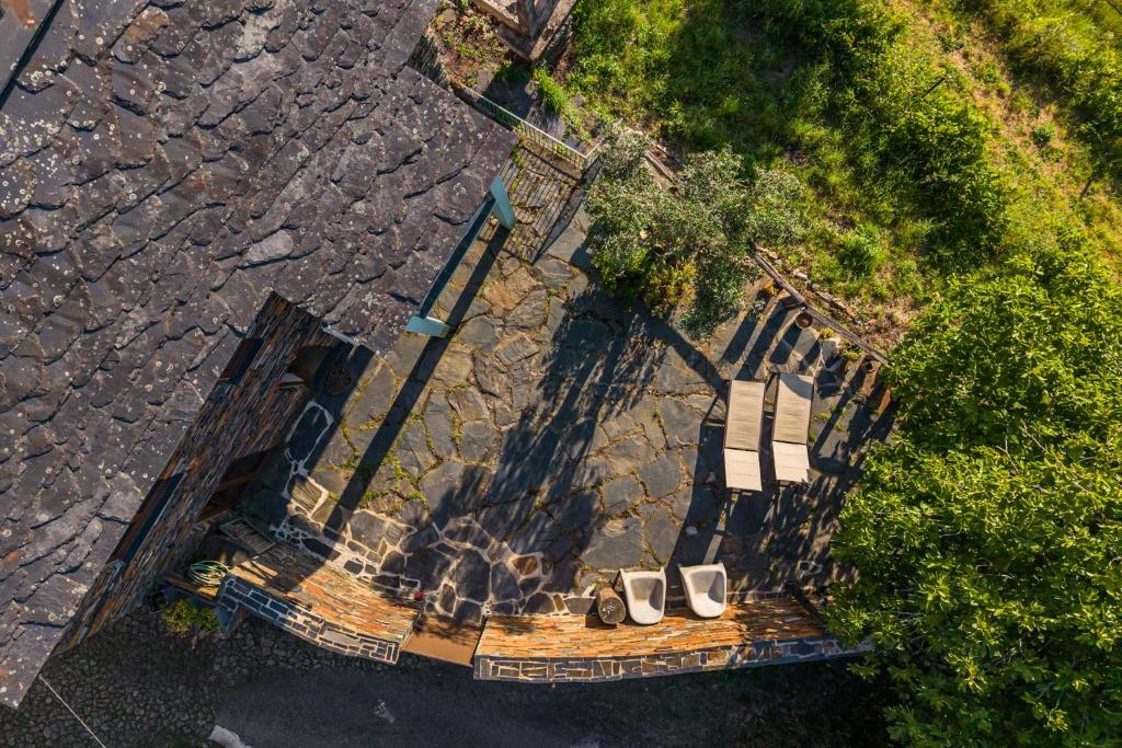 an overhead view of a pair of shoes on a bench at Casa da Figueira - Rio Paiva in Arouca