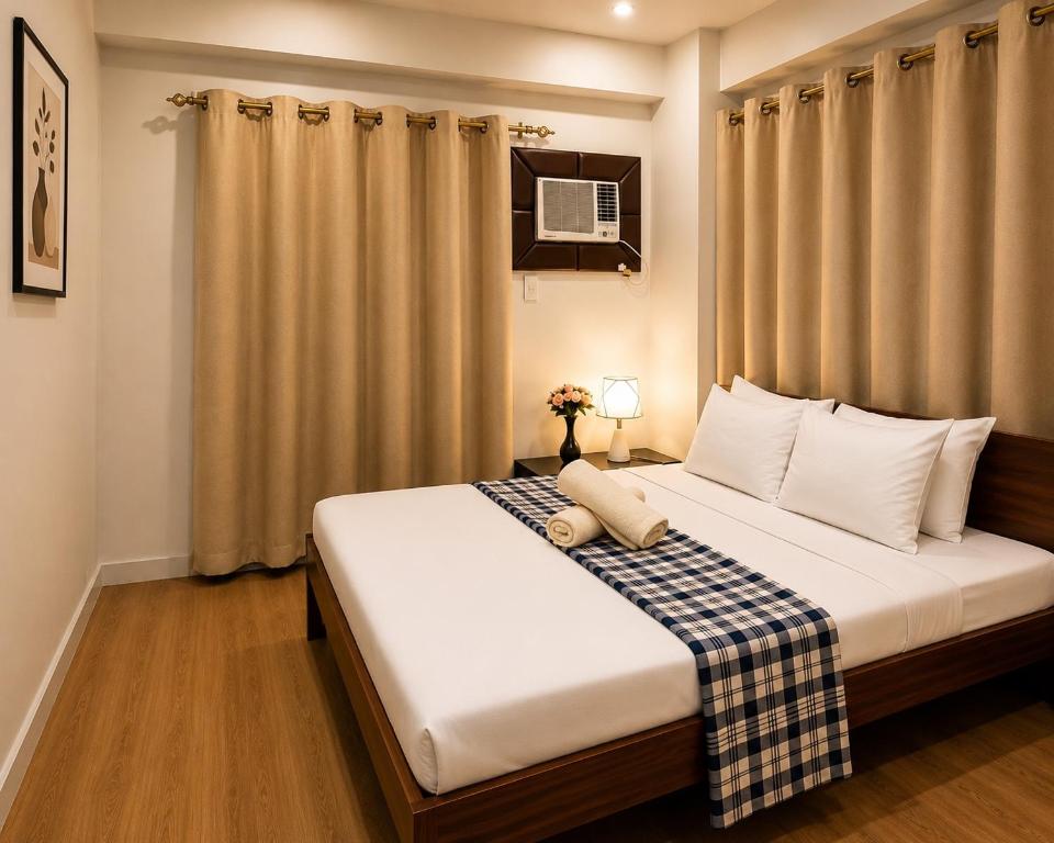 a bedroom with a large bed with white pillows at Davao City Stay at Camella Northpoint Spacious 3BR Condo 5Beds Up to 10 Guests in Davao City
