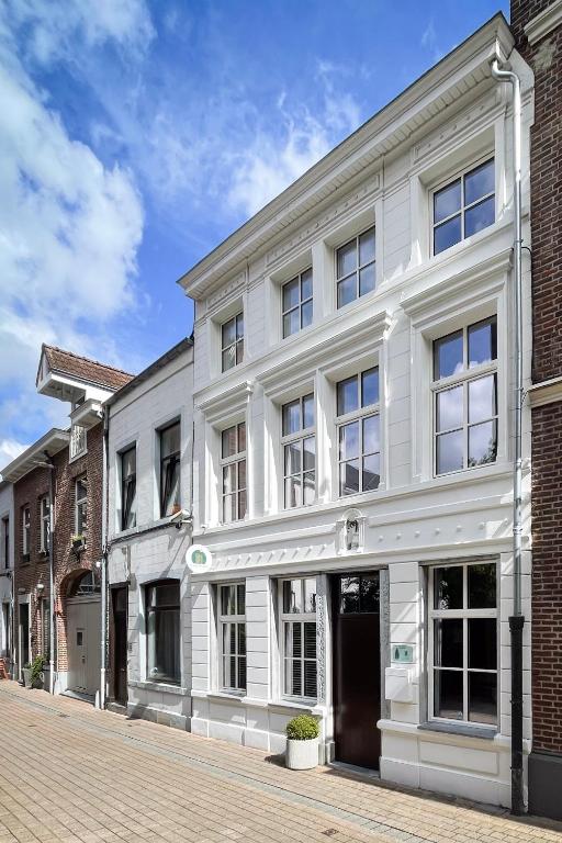 a white building on a city street at Maison Dieu in Hasselt