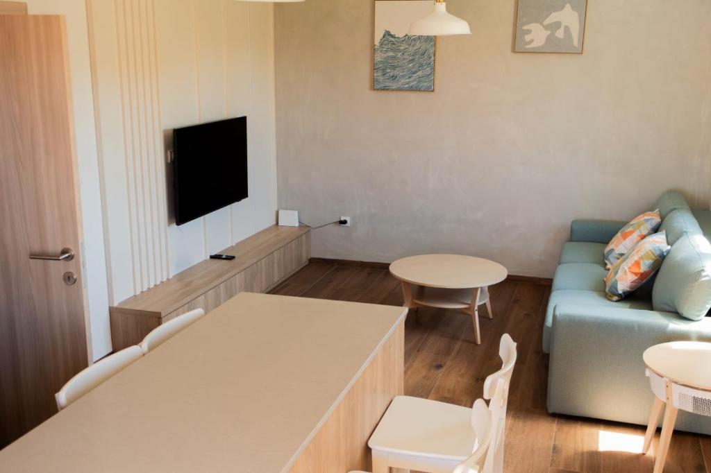 a living room with a couch and a table at Apartment Solis 8 in Stara Novalja